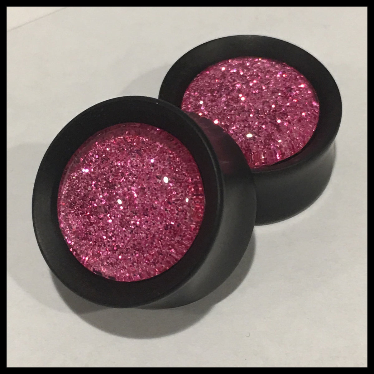 Ebony Hot Pink Sparkle Round Plugs
