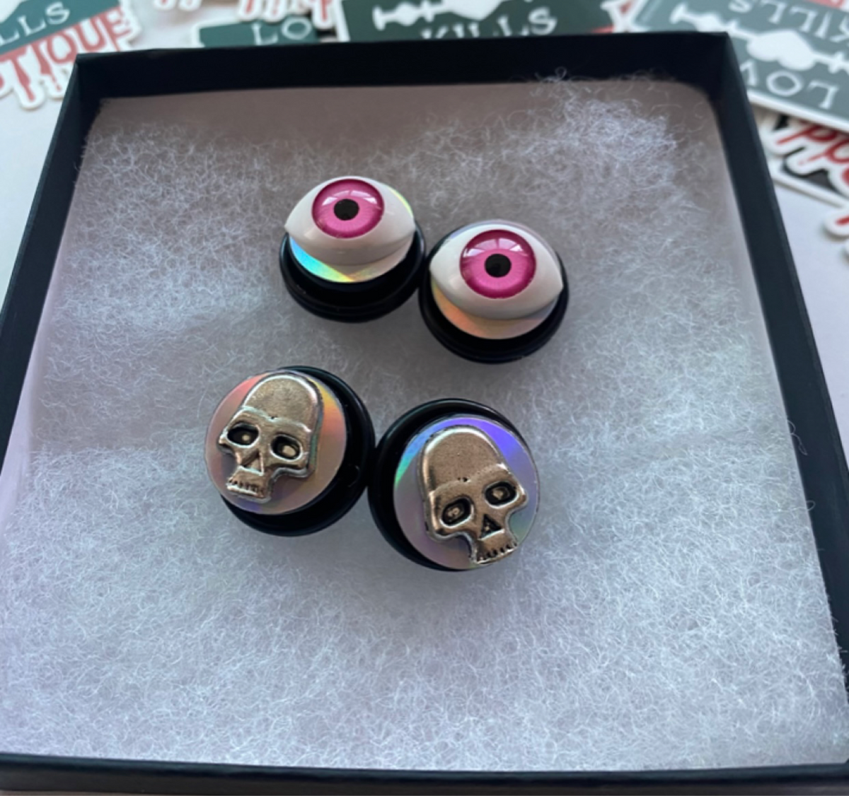 skull and eyeball plugs for stretched lobes.